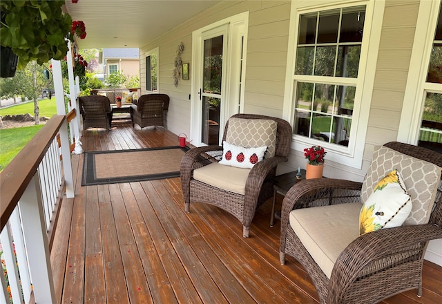 wooden terrace featuring covered porch