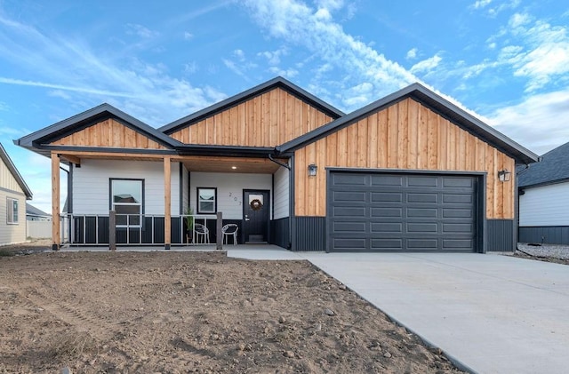 view of front of property with a porch and a garage