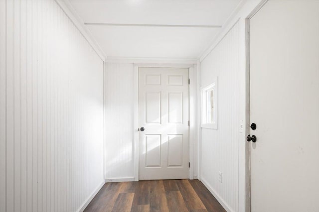 hall with dark hardwood / wood-style flooring and ornamental molding