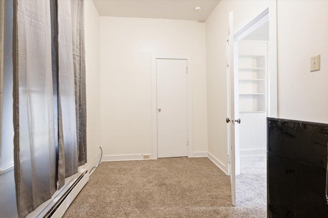 interior space with baseboard heating and carpet