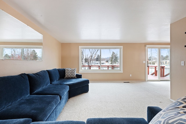 living room with a healthy amount of sunlight and carpet