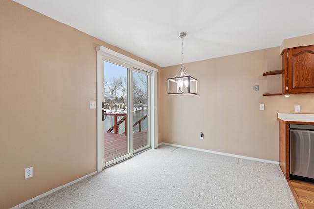 unfurnished dining area with light carpet and a notable chandelier