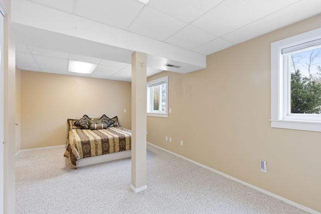 bedroom with a paneled ceiling and carpet flooring