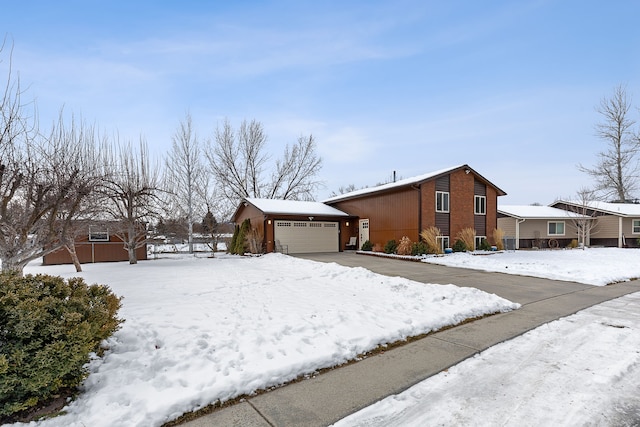 single story home with a garage and an outbuilding