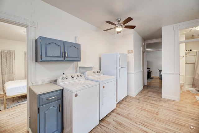 washroom featuring light hardwood / wood-style floors, washer and clothes dryer, and ceiling fan