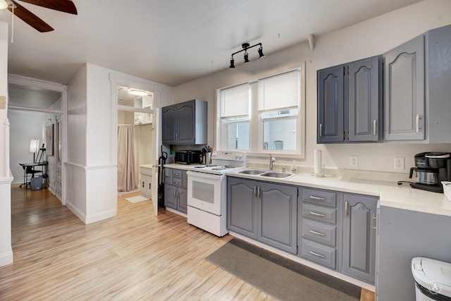 kitchen with light hardwood / wood-style floors, sink, gray cabinetry, and white electric range