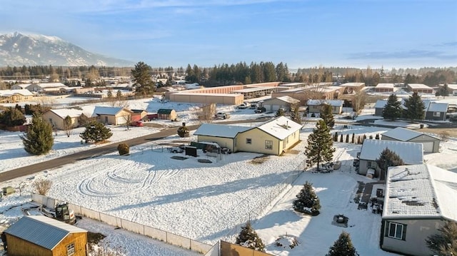 snowy aerial view featuring a mountain view