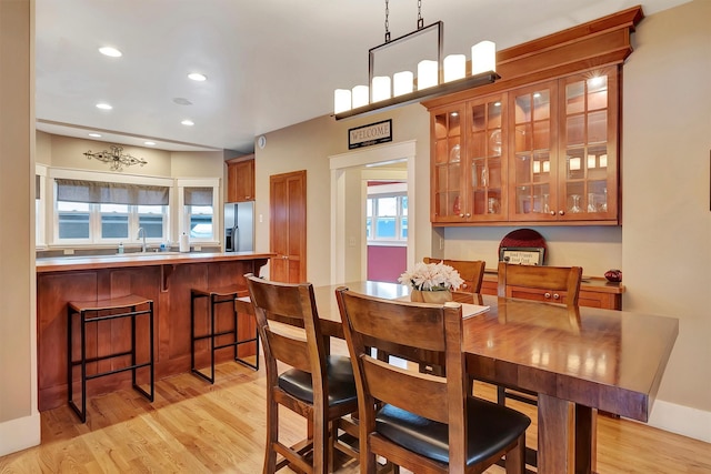 dining space featuring sink and light hardwood / wood-style flooring