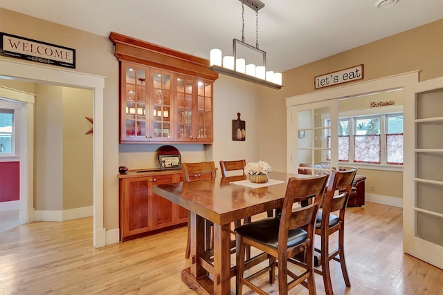 dining space with light hardwood / wood-style floors