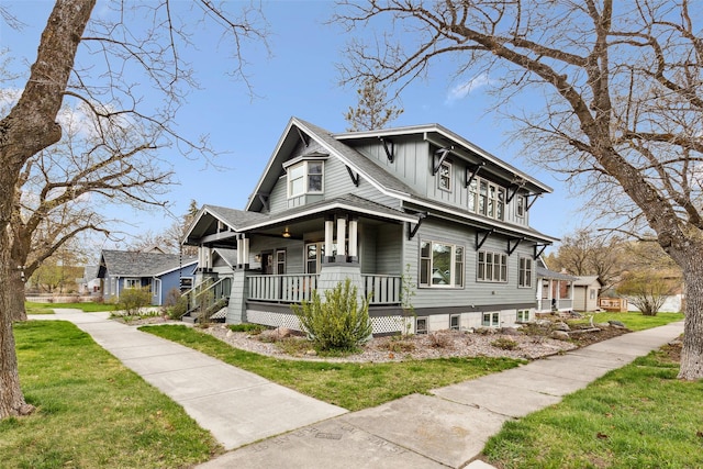 view of front of property with covered porch and a front yard