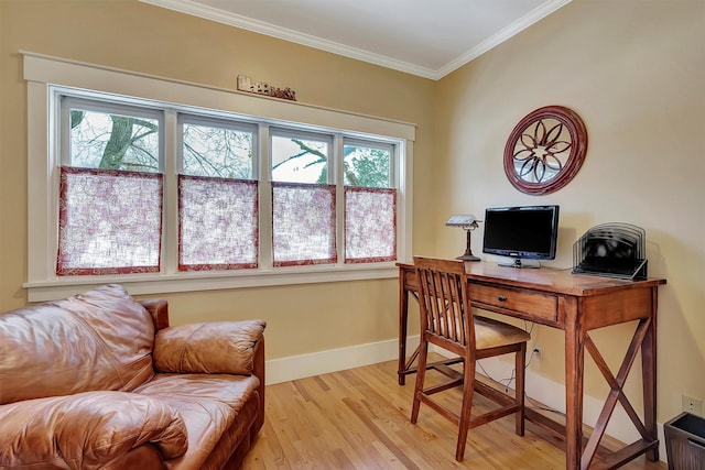 office area with light hardwood / wood-style flooring and crown molding