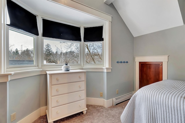 carpeted bedroom with a baseboard heating unit and vaulted ceiling