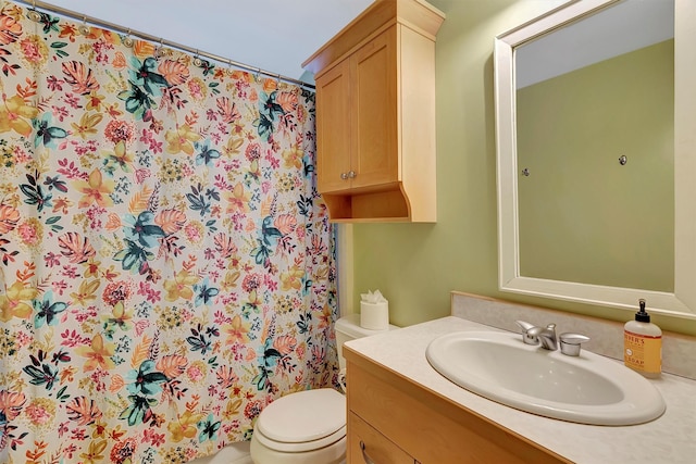 bathroom featuring vanity, toilet, and walk in shower