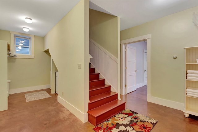 stairway featuring concrete flooring