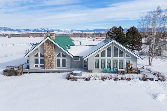 snow covered house with a mountain view