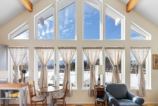 sunroom featuring a healthy amount of sunlight and beamed ceiling