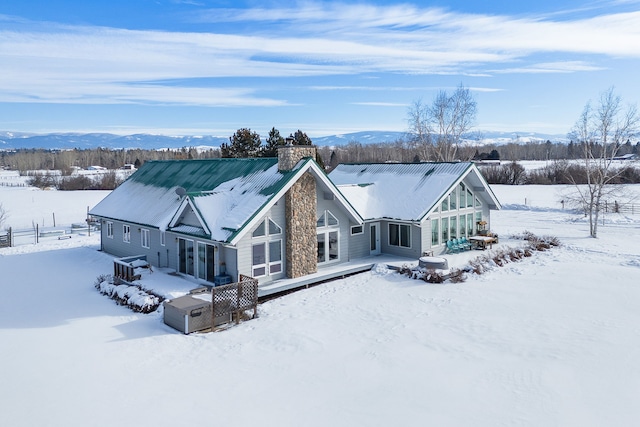 snow covered property with a mountain view