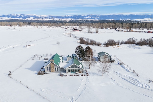 snowy aerial view featuring a mountain view