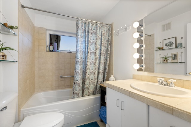 full bathroom with shower / bath combo with shower curtain, toilet, and vanity