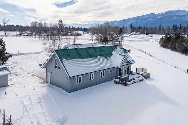 snowy aerial view featuring a mountain view