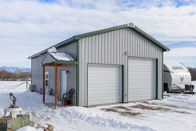 snow covered garage with a mountain view