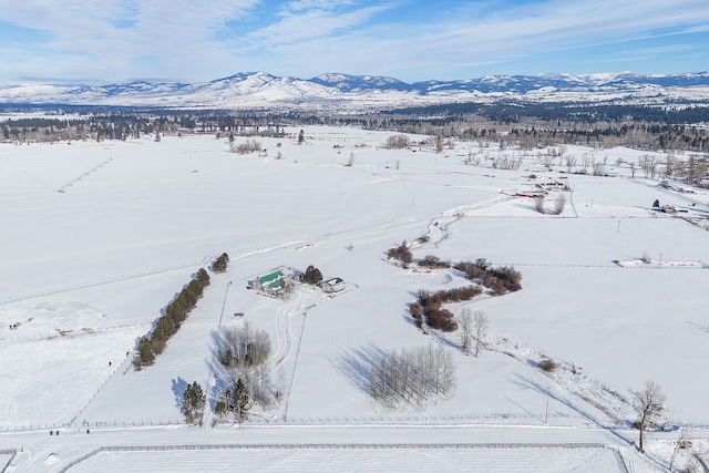 snowy aerial view featuring a mountain view