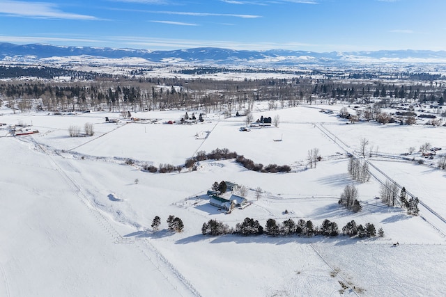 snowy aerial view with a mountain view