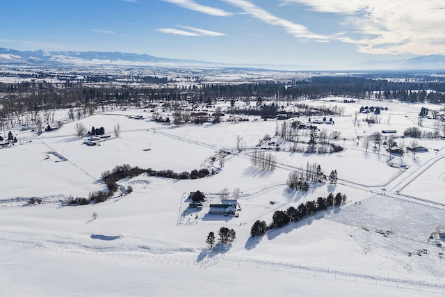 snowy aerial view with a mountain view