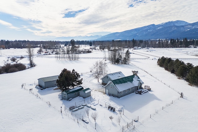 snowy aerial view featuring a mountain view