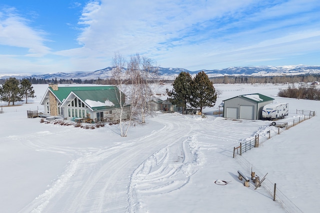 snowy aerial view with a mountain view