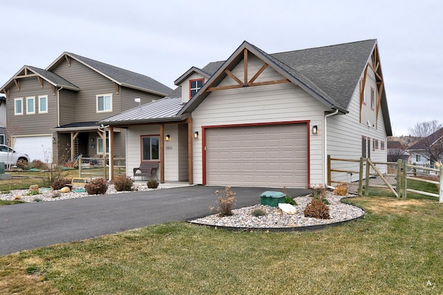 view of front facade with a garage, covered porch, and a front yard