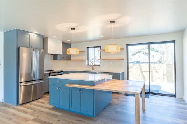 230 Fox Farm Dr, Whitefish, MT 59937 - kitchen with freestanding refrigerator, open shelves, light countertops, a center island, and hanging light fixtures