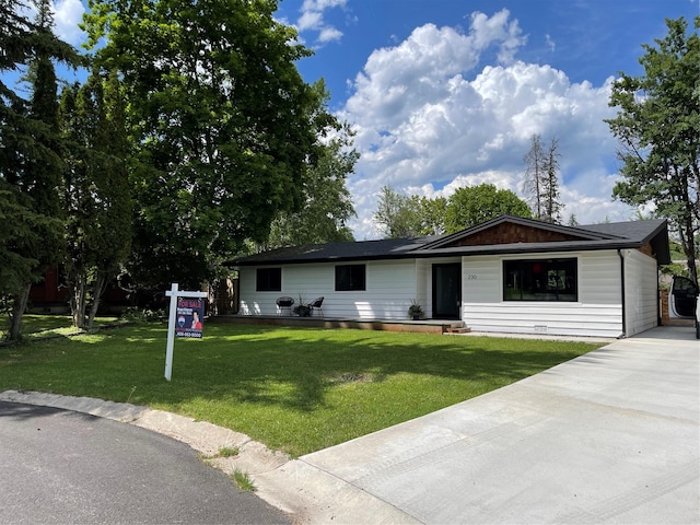 230 Fox Farm Dr, Whitefish, MT 59937 - ranch-style home with a front lawn and concrete driveway