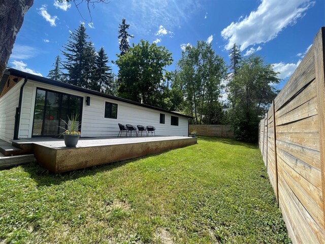 230 Fox Farm Dr, Whitefish, MT 59937 - rear view of house featuring a fenced backyard and a patio area