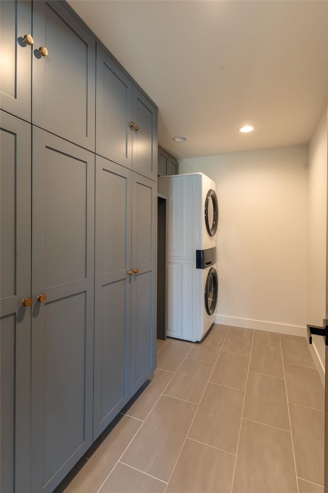 230 Fox Farm Dr, Whitefish, MT 59937 - laundry area featuring stacked washer and clothes dryer, cabinet space, recessed lighting, and light tile patterned floors