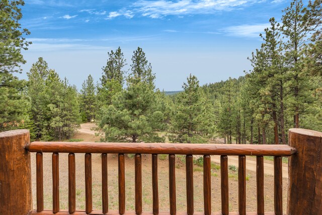 2122 Lightning Draw Trl, Victor, MT 59875 - wooden terrace with a wooded view