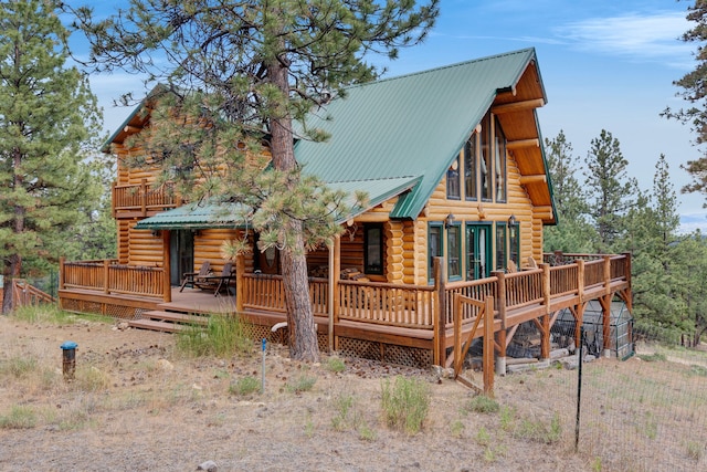2122 Lightning Draw Trl, Victor, MT 59875 - back of house with log siding, a deck, and metal roof