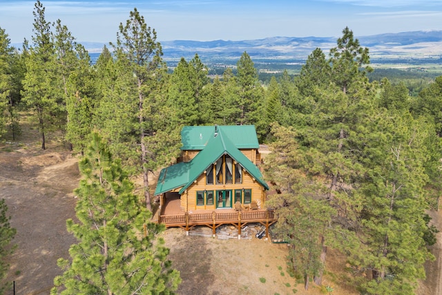 2122 Lightning Draw Trl, Victor, MT 59875 - rear view of house with a forest view, metal roof, and a deck with mountain view