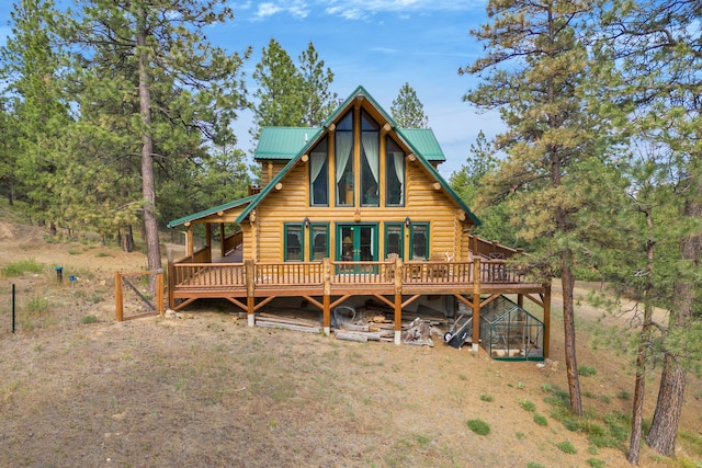 2122 Lightning Draw Trl, Victor, MT 59875 - view of front of property featuring log exterior, a deck, and metal roof