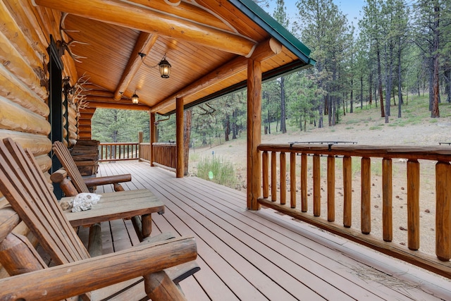 2122 Lightning Draw Trl, Victor, MT 59875 - wooden porch with view of scattered trees