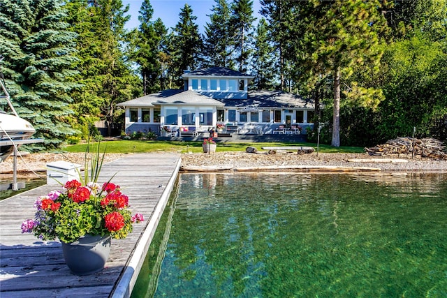 rear view of property featuring a yard and a water view