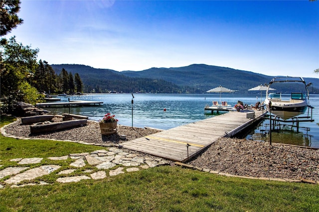 view of dock with a water and mountain view