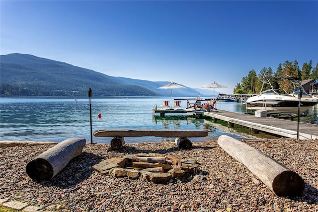 view of dock with a water and mountain view