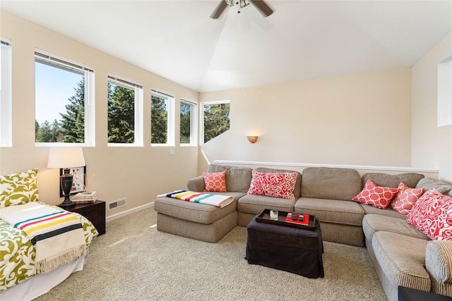 carpeted living room with ceiling fan and lofted ceiling