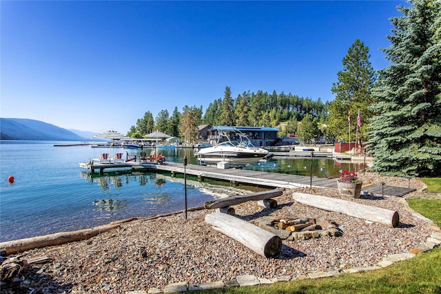 view of dock with a water and mountain view