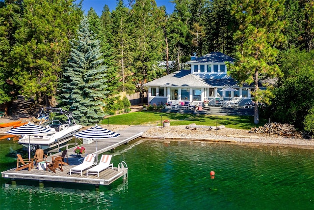 dock area with a yard and a deck with water view