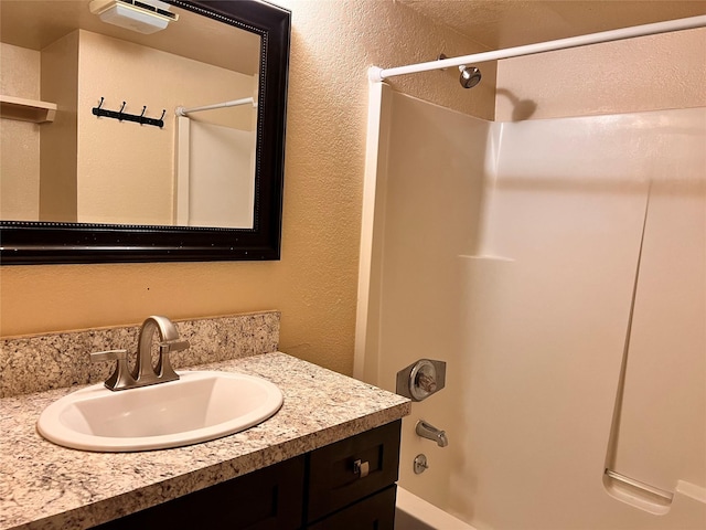 bathroom with shower / tub combination and vanity