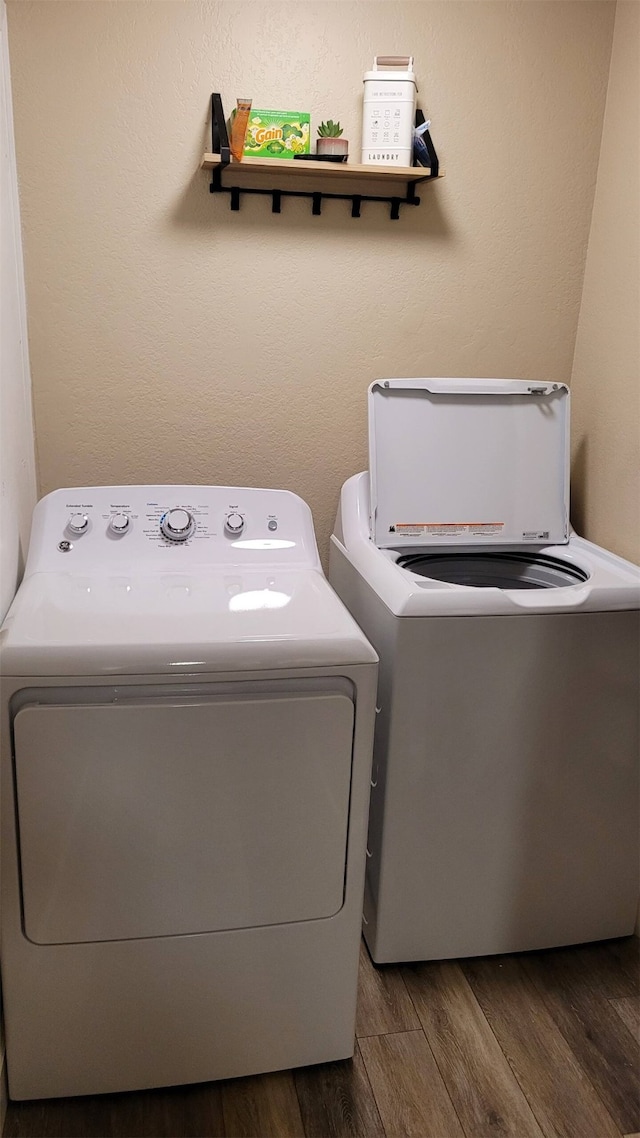 washroom featuring washer and dryer and dark wood-type flooring