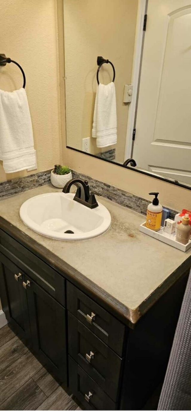 bathroom featuring vanity and wood-type flooring