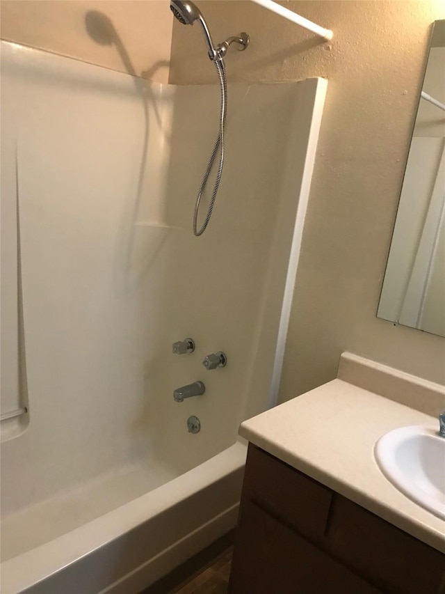 bathroom with vanity and bathtub / shower combination